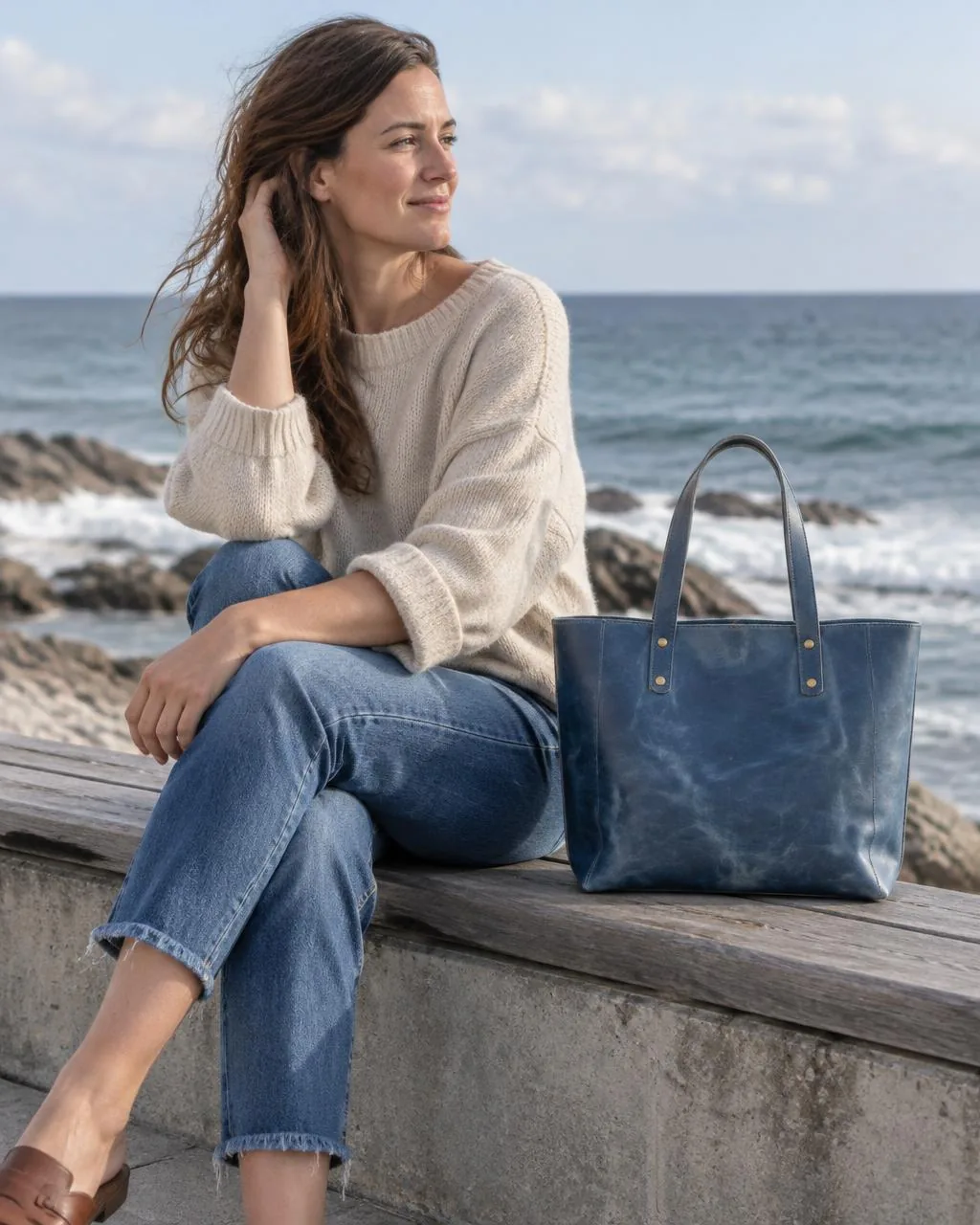 The Vancouver Tote in blue, beside a woman on a seawall bench, WACCO Studio Vancouver