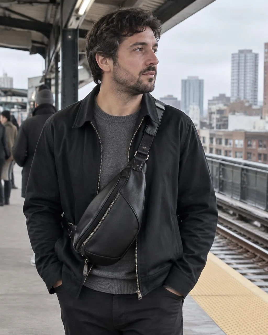 Active Flex Sling in black, worn across the chest on a train platform, WACCO Studio Vancouver